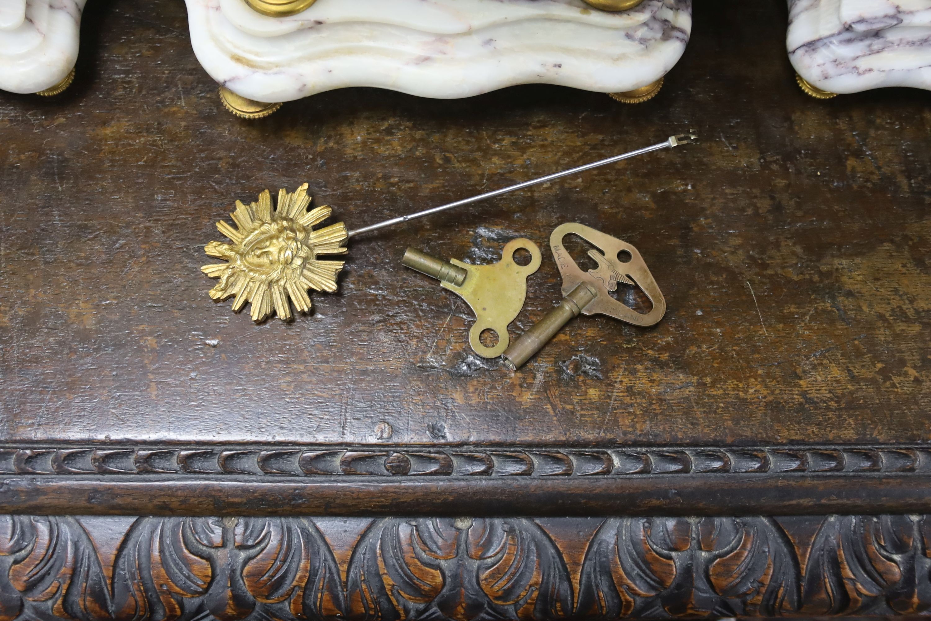 A late 19th century French three piece clock set, in Louis XVI taste with key and pendulum 42cm